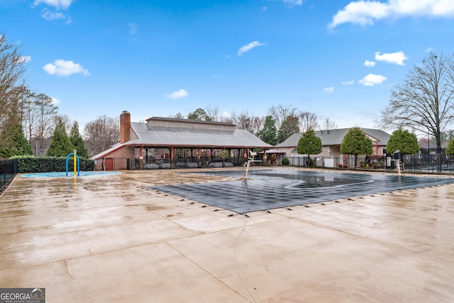 view of pool with a patio and fence