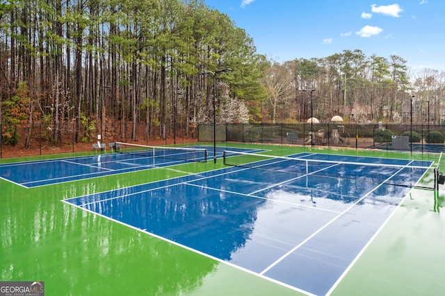 view of tennis court with fence