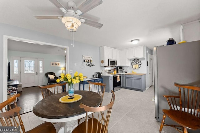 dining area featuring light tile patterned floors and ceiling fan