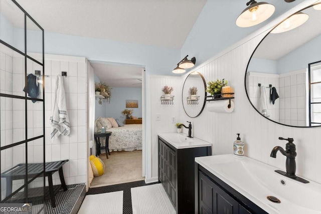 bathroom featuring connected bathroom, vaulted ceiling, and a sink