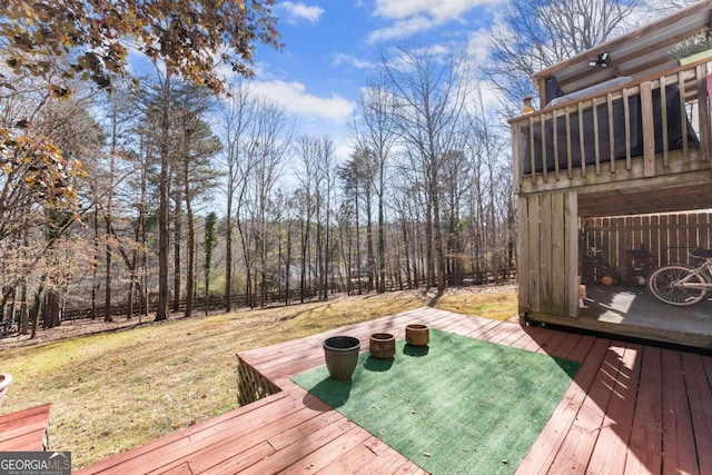 wooden terrace with fence and a lawn