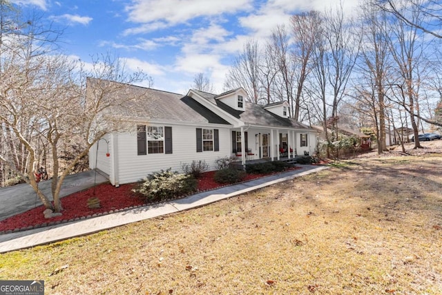 cape cod home with driveway and a porch