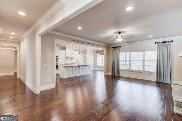 unfurnished living room featuring ceiling fan, baseboards, and dark wood-style flooring