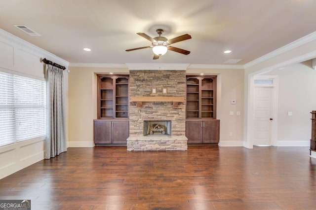 unfurnished living room featuring ornamental molding, visible vents, a fireplace, and wood finished floors