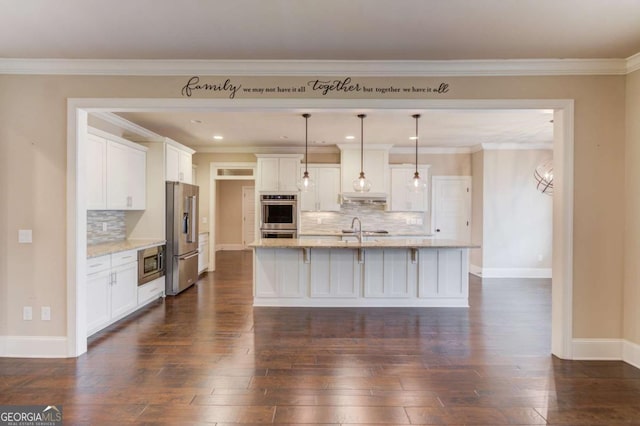 kitchen with white cabinets, appliances with stainless steel finishes, dark wood-type flooring, under cabinet range hood, and a sink