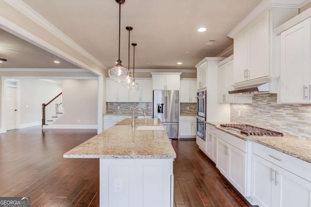 kitchen featuring dark wood-style floors, appliances with stainless steel finishes, under cabinet range hood, white cabinetry, and a sink