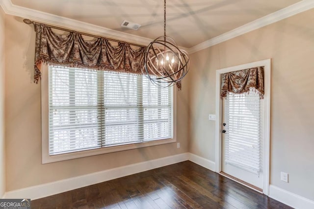 unfurnished dining area featuring visible vents, ornamental molding, dark wood finished floors, and baseboards