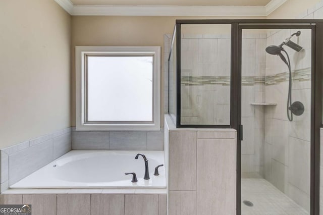 bathroom with a stall shower, a garden tub, and crown molding