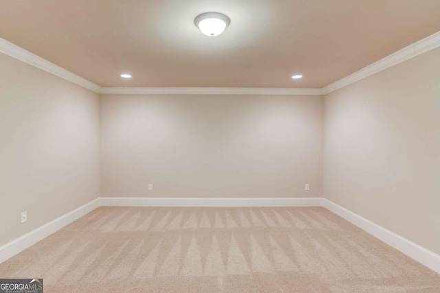 empty room with baseboards, ornamental molding, and light colored carpet