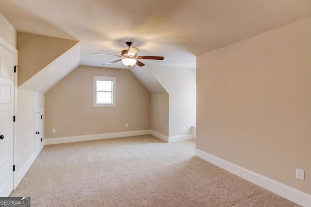 bonus room featuring vaulted ceiling, light carpet, ceiling fan, and baseboards