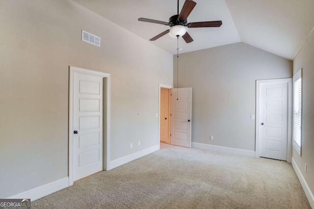 unfurnished bedroom with light carpet, baseboards, visible vents, ceiling fan, and vaulted ceiling