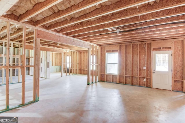 miscellaneous room featuring a healthy amount of sunlight and concrete flooring