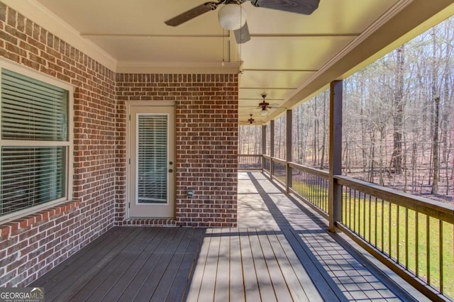 wooden terrace featuring a ceiling fan