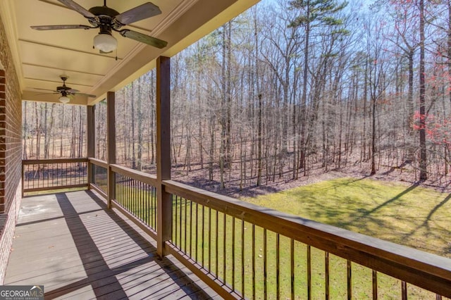 deck featuring ceiling fan and a yard