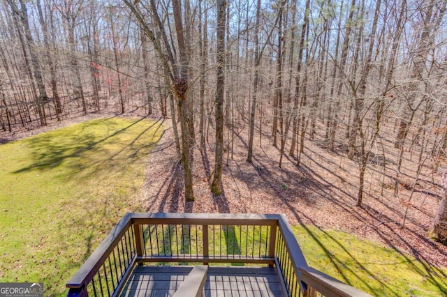 wooden terrace featuring a yard