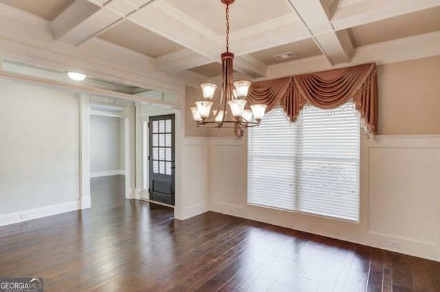 unfurnished dining area with plenty of natural light, beam ceiling, and dark wood finished floors