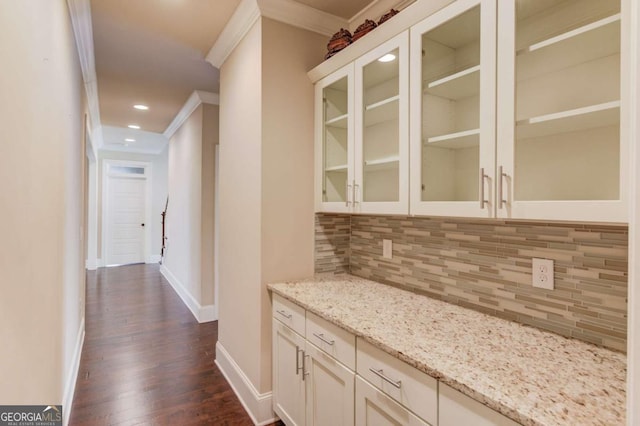 interior space with ornamental molding, recessed lighting, dark wood finished floors, and baseboards