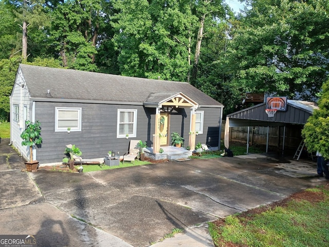 2077 Brockett Rd, Tucker, GA 30084 - view of front of property featuring a detached carport, concrete driveway, and a shingled roof