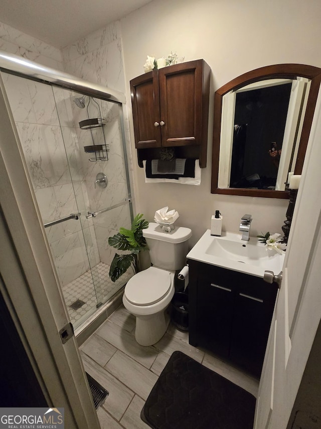2077 Brockett Rd, Tucker, GA 30084 - full bathroom featuring vanity, toilet, and a stall shower
