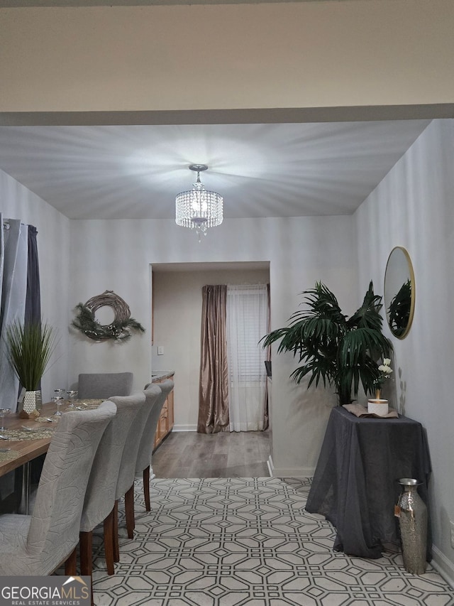 2077 Brockett Rd, Tucker, GA 30084 - dining space featuring a chandelier, baseboards, and light wood-type flooring
