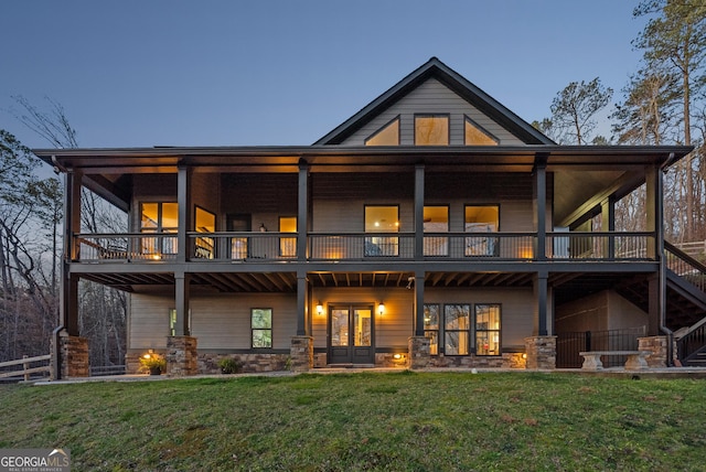 rear view of property featuring french doors and a yard