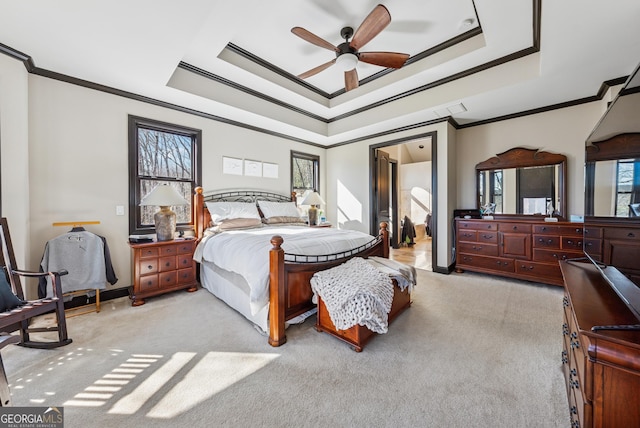 bedroom featuring a raised ceiling, light colored carpet, crown molding, and visible vents