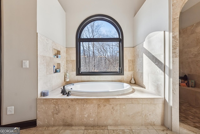 bathroom featuring a bath and tile patterned floors