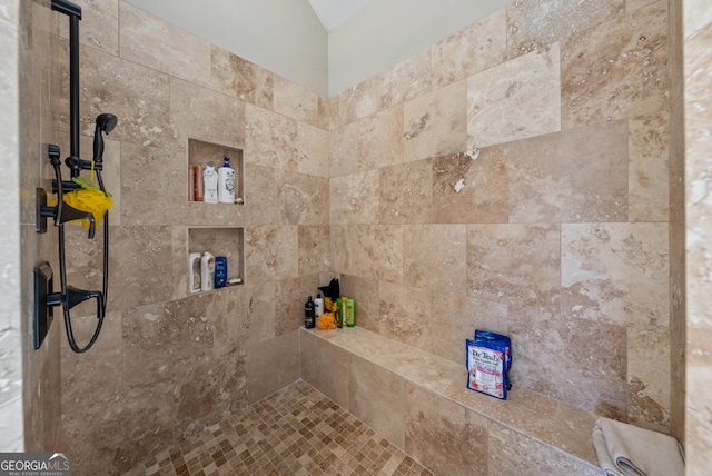 full bath with a tile shower