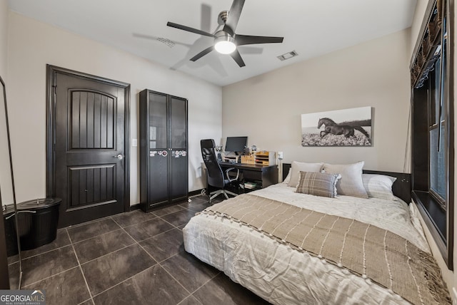 bedroom with dark tile patterned floors, visible vents, and ceiling fan