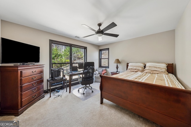 bedroom with ceiling fan, visible vents, and carpet flooring