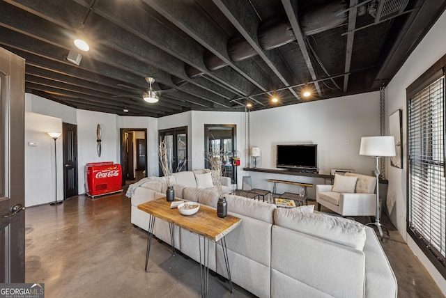 living room featuring concrete flooring and french doors