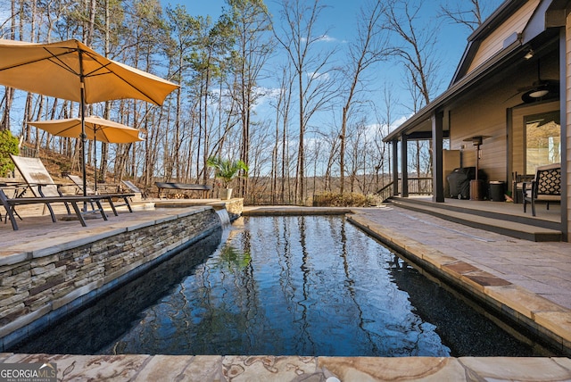 view of swimming pool with fence, a fenced in pool, and a patio