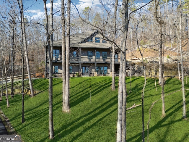 back of house with a lawn