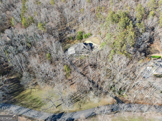 birds eye view of property featuring a wooded view