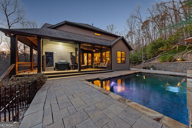 view of swimming pool featuring a fenced in pool, a patio area, and a grill