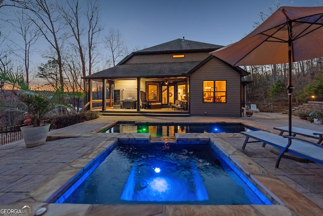 view of pool featuring a fenced in pool, fence, a patio, and an in ground hot tub