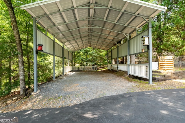 view of parking with gravel driveway and a carport