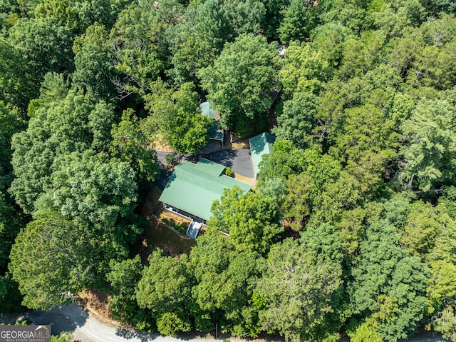 birds eye view of property featuring a wooded view