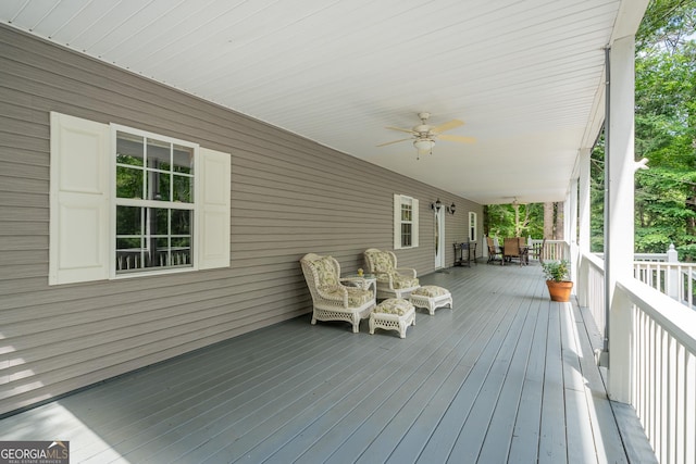 wooden terrace featuring a ceiling fan