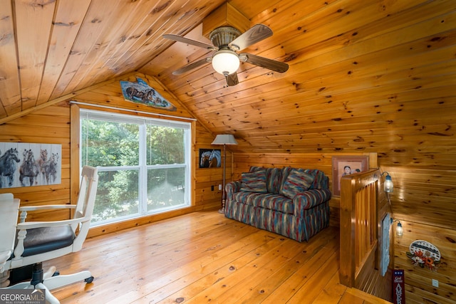 interior space with ceiling fan, hardwood / wood-style flooring, vaulted ceiling, wood ceiling, and wood walls