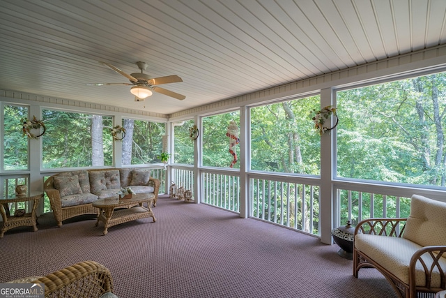 sunroom / solarium with a ceiling fan and a wealth of natural light