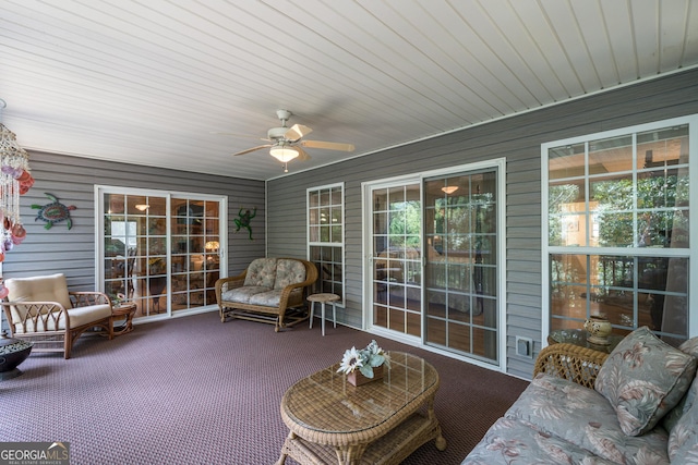 sunroom / solarium featuring plenty of natural light and ceiling fan