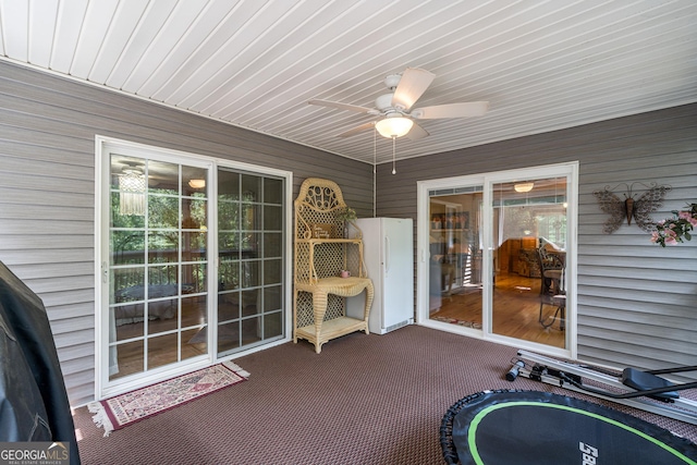 unfurnished sunroom featuring plenty of natural light and ceiling fan