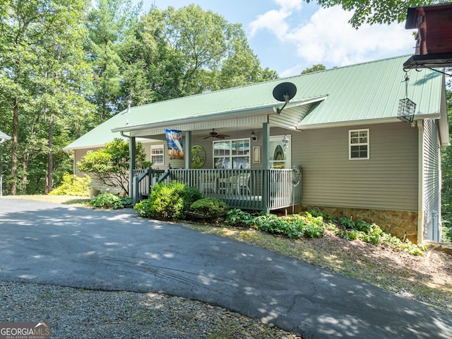 view of front of property with a ceiling fan and metal roof