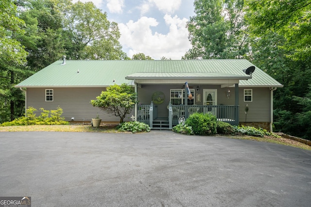 view of front of property with a porch and metal roof