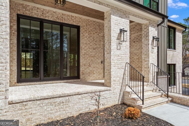 entrance to property featuring brick siding