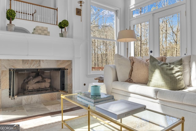 living room featuring french doors and a premium fireplace