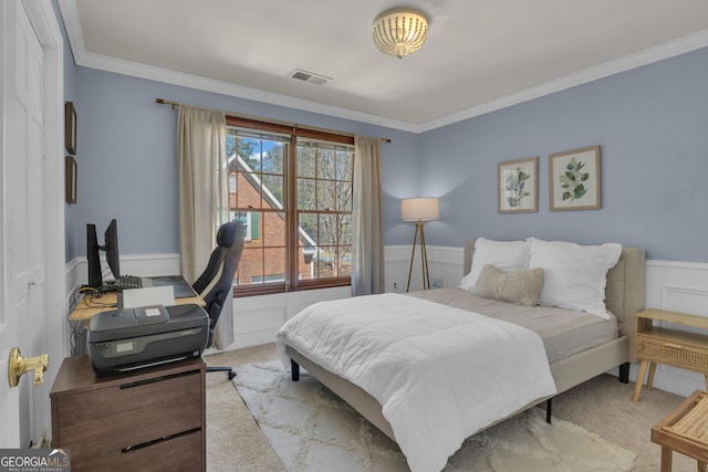 carpeted bedroom with ornamental molding, visible vents, and wainscoting