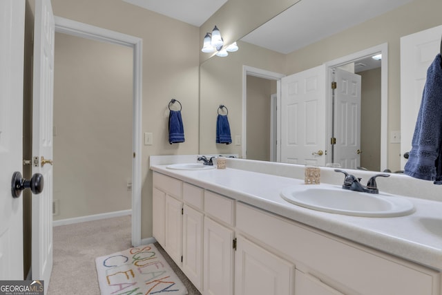 full bathroom featuring double vanity, baseboards, and a sink