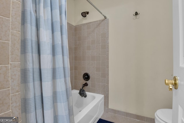 full bathroom featuring tile patterned floors, toilet, and shower / bathtub combination with curtain